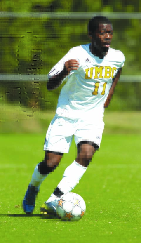 Levi kicks soccer ball in UMBC gear