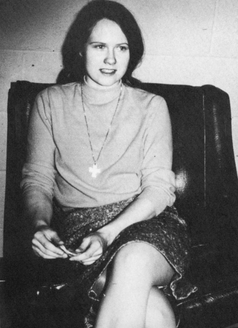 Black and white photo girl sits on arm chair