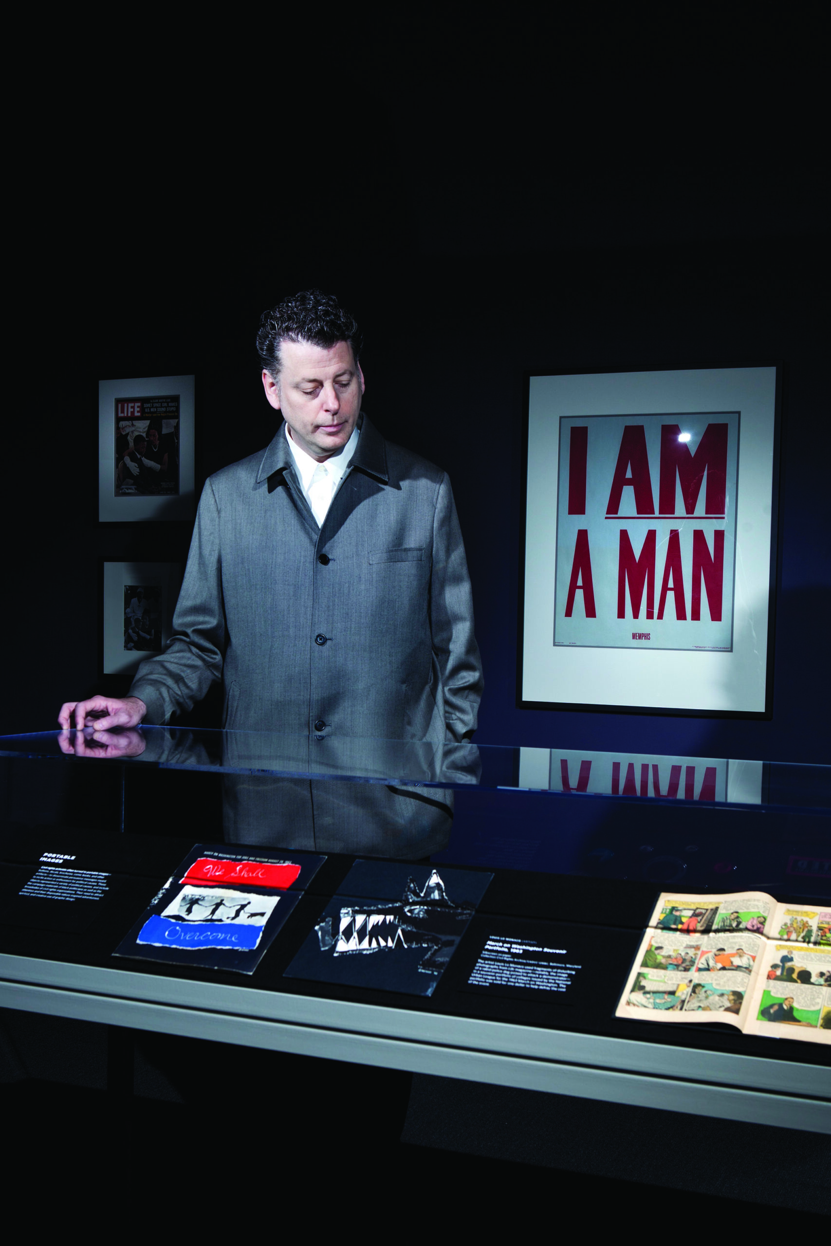 Maurice Berger poses in the "For All The World To See: Visual Culture and the Struggle for Civil Rights" exhibit in the National Museum of African American History and Culture Gallery of the Smithsonian's American History Museum July 27, 2011 in Washington, DC.  The traveling exhibit, which focuses on the power of visual media, is on display to November 27 and is organized by the Center for Art, Design and Visual Culture at the University of Maryland and the National Museum of African American History and Culture
