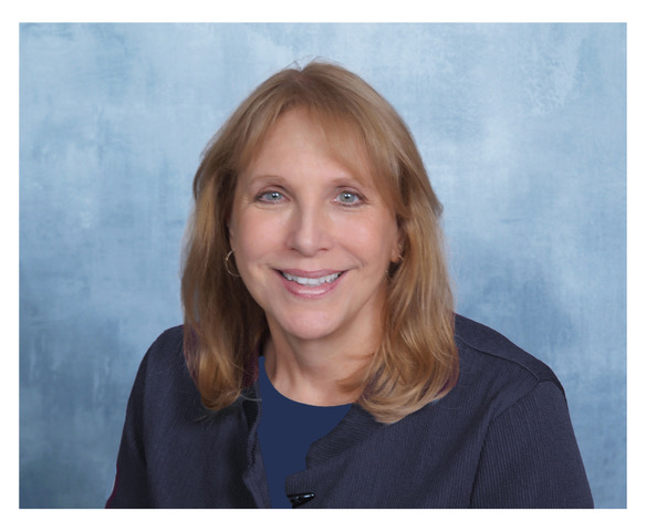 headshot of lisa Urkevich in a blue blouse and jacket