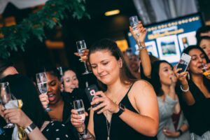 Group hold wine glasses at UMBC grad dance