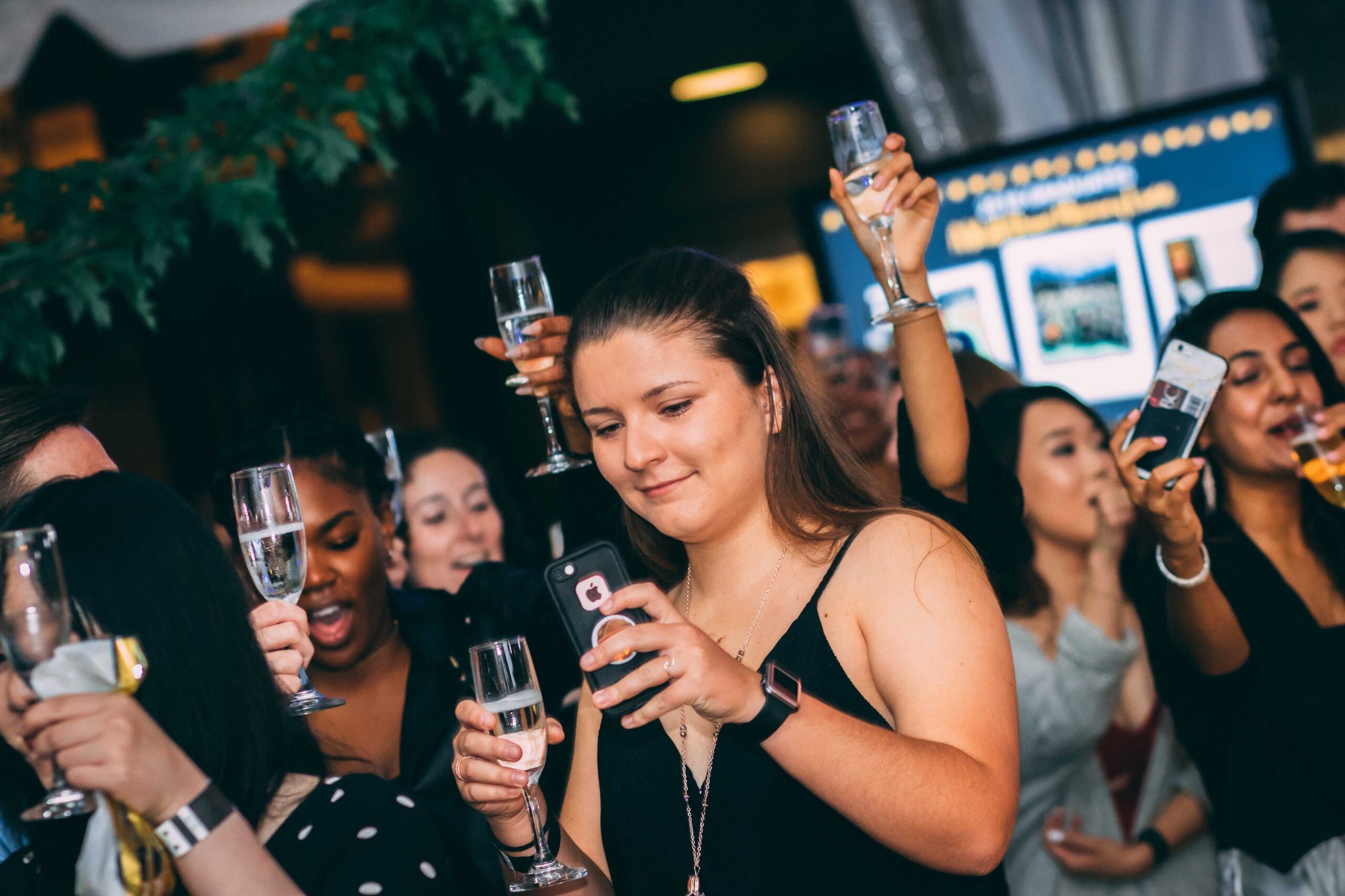 Group hold wine glasses at UMBC grad dance