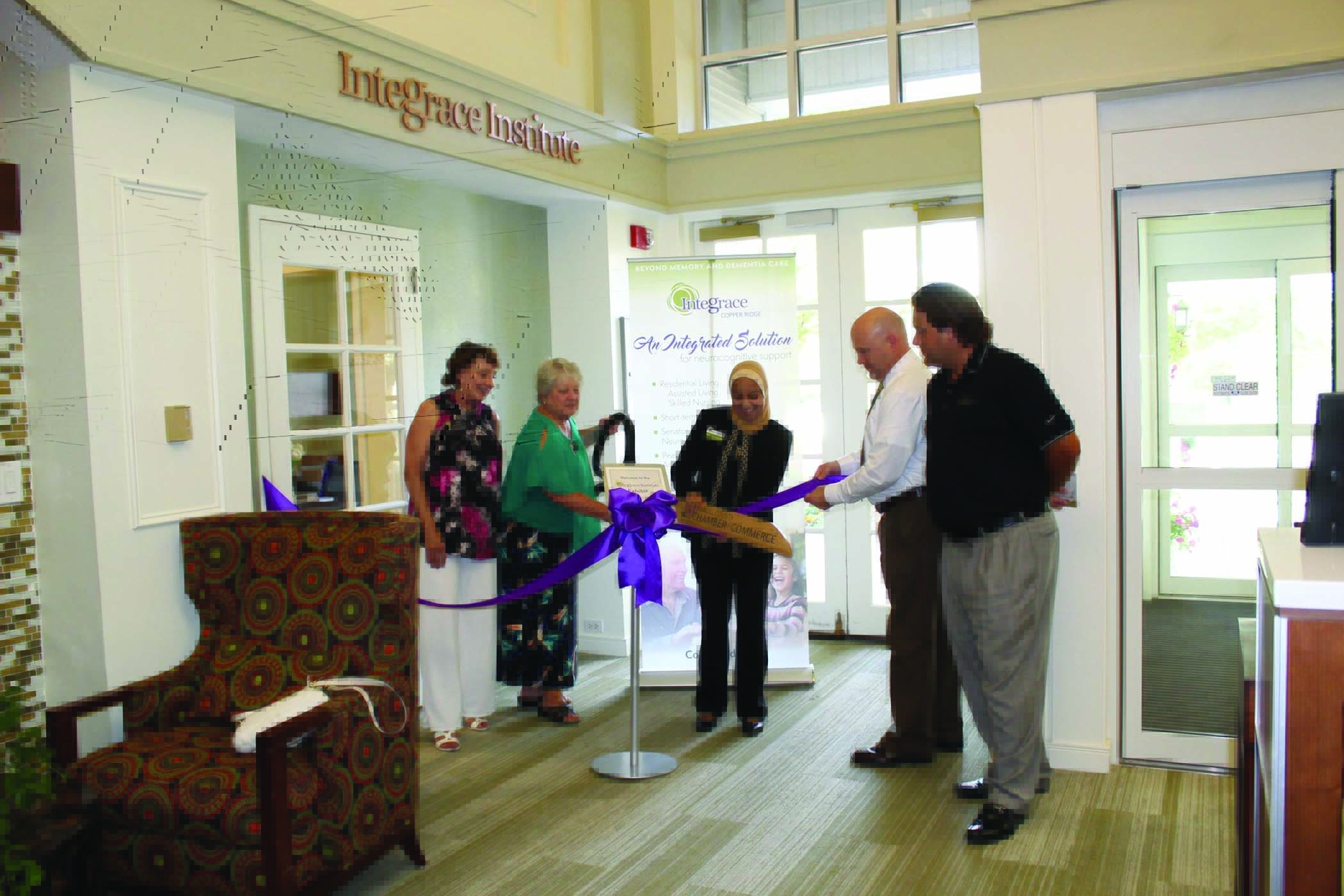 Majid cuts the ribbon at the launch of an exhibit created at Integrace Institute through collaborations with UMBC students. Image courtesy of Integrace Institute.