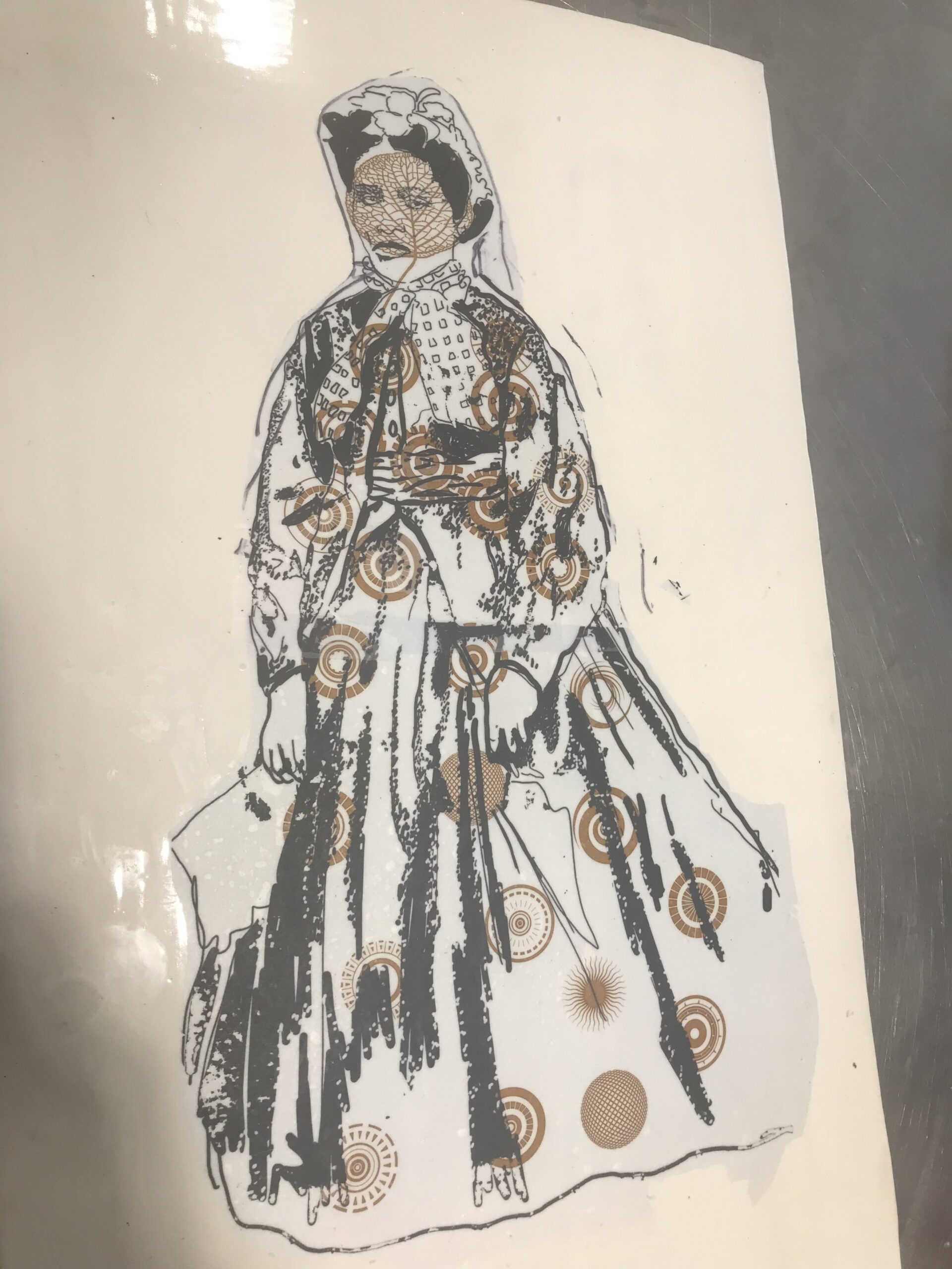 close up of women sketched in stone in dress with gold patterns on it