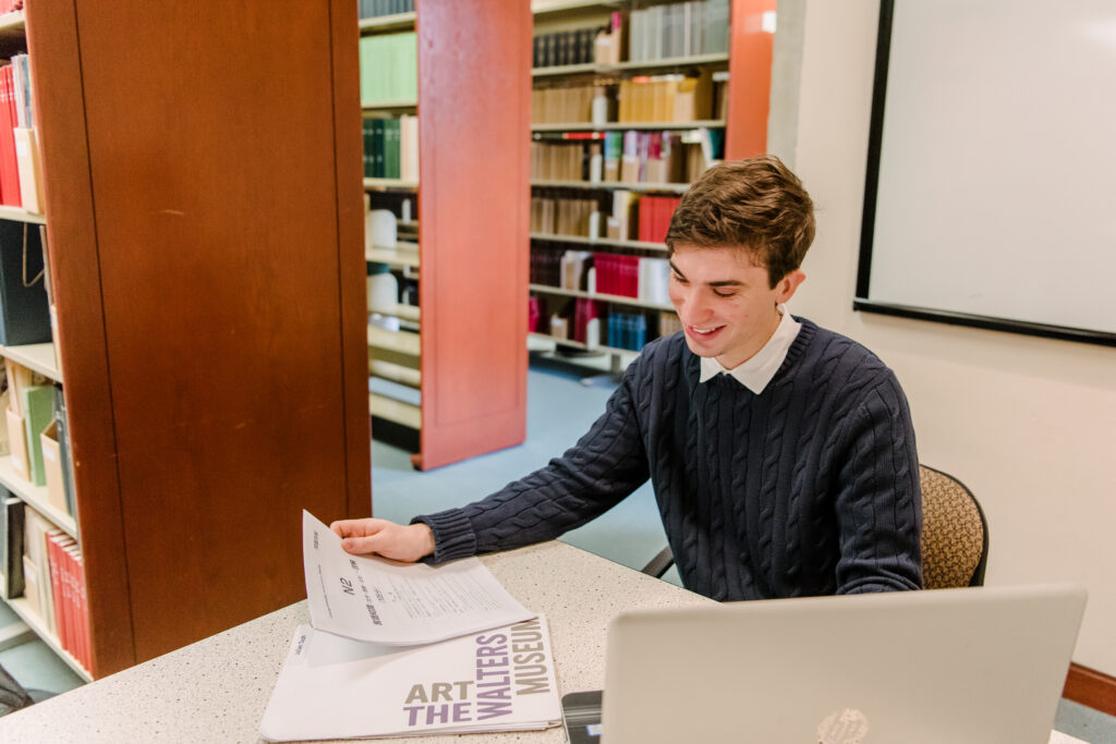 Male student reading in library
