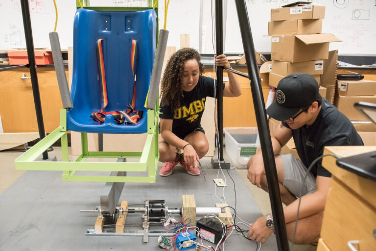 Students work to create a motorized swing.