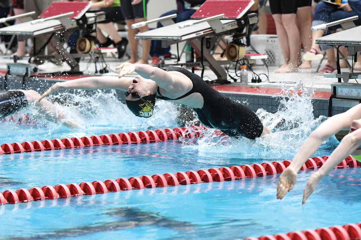 Haylee Committee hugs Tonia Papapertrou after the 100 freestyle. Photo by Colleen Humel.