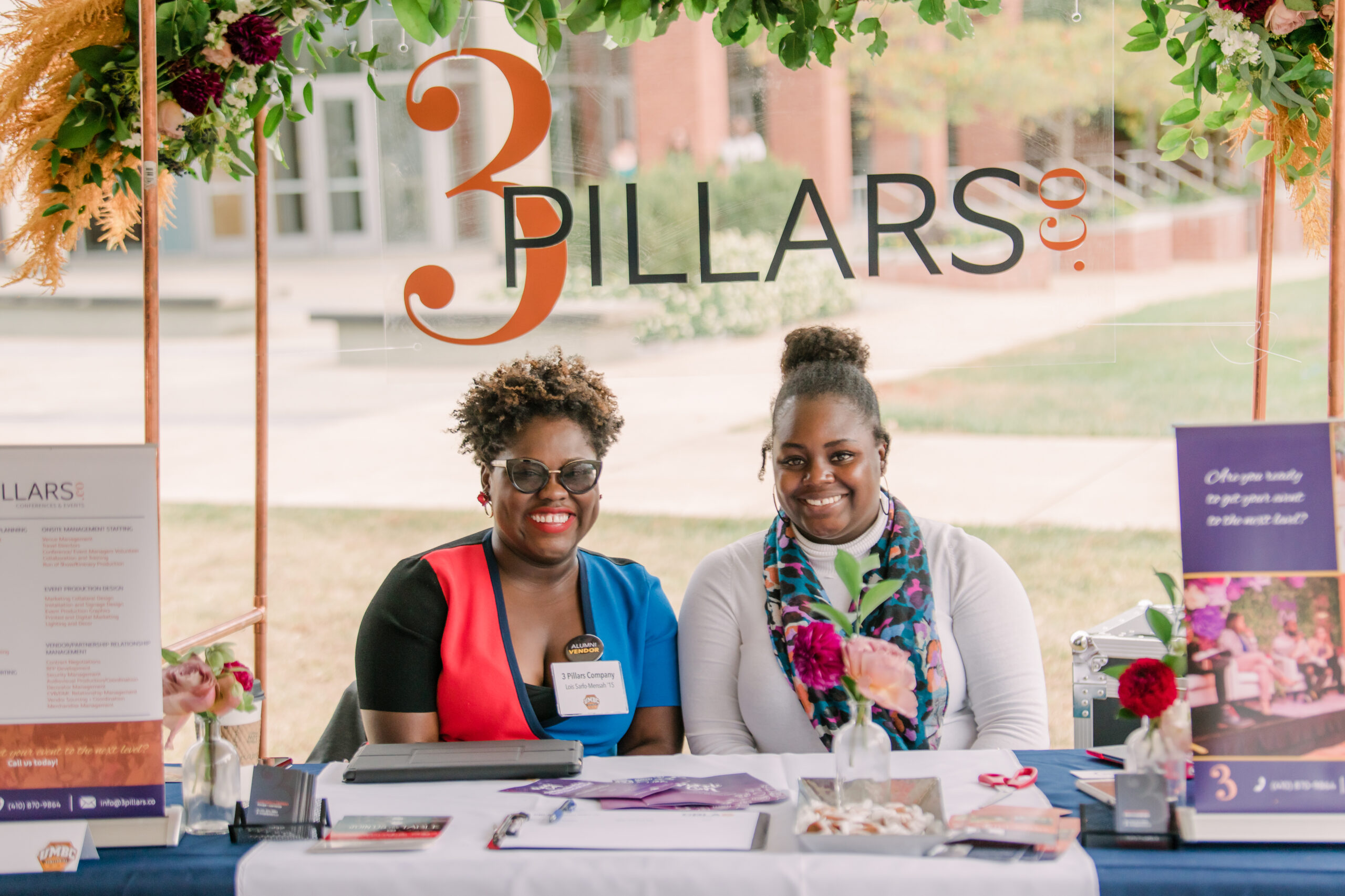 3 pillars co with two woman sitting at table
