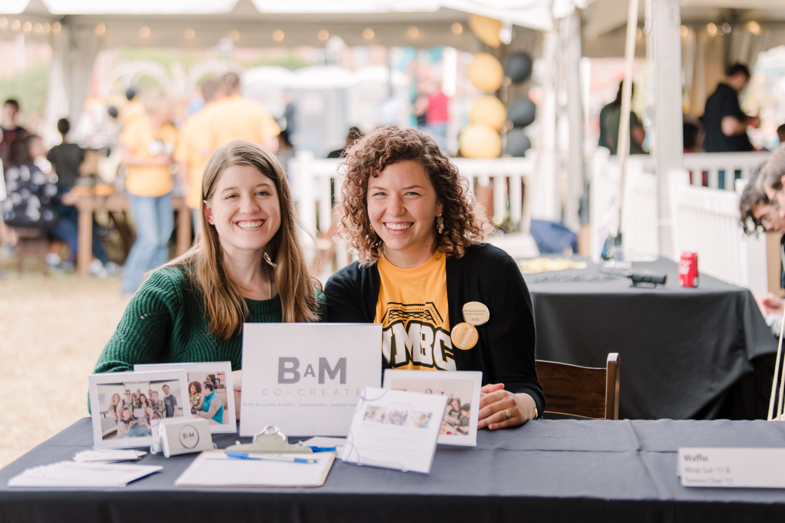 Alumnae smile at Co create table