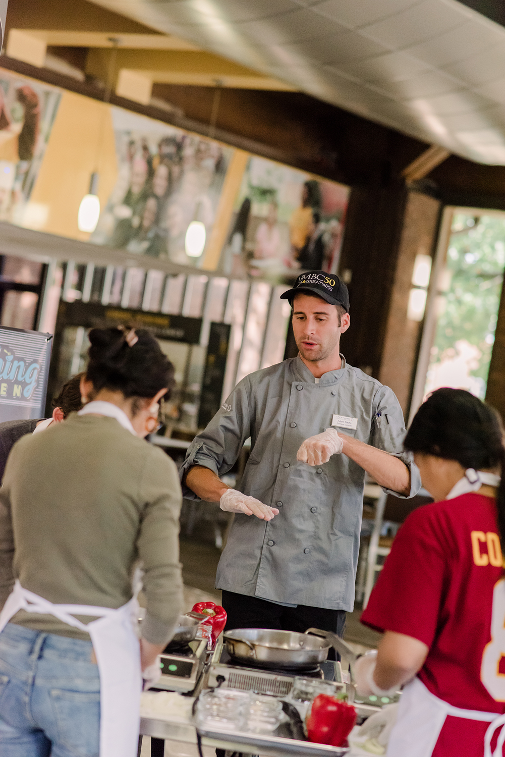 chef instructs students in cutting methods