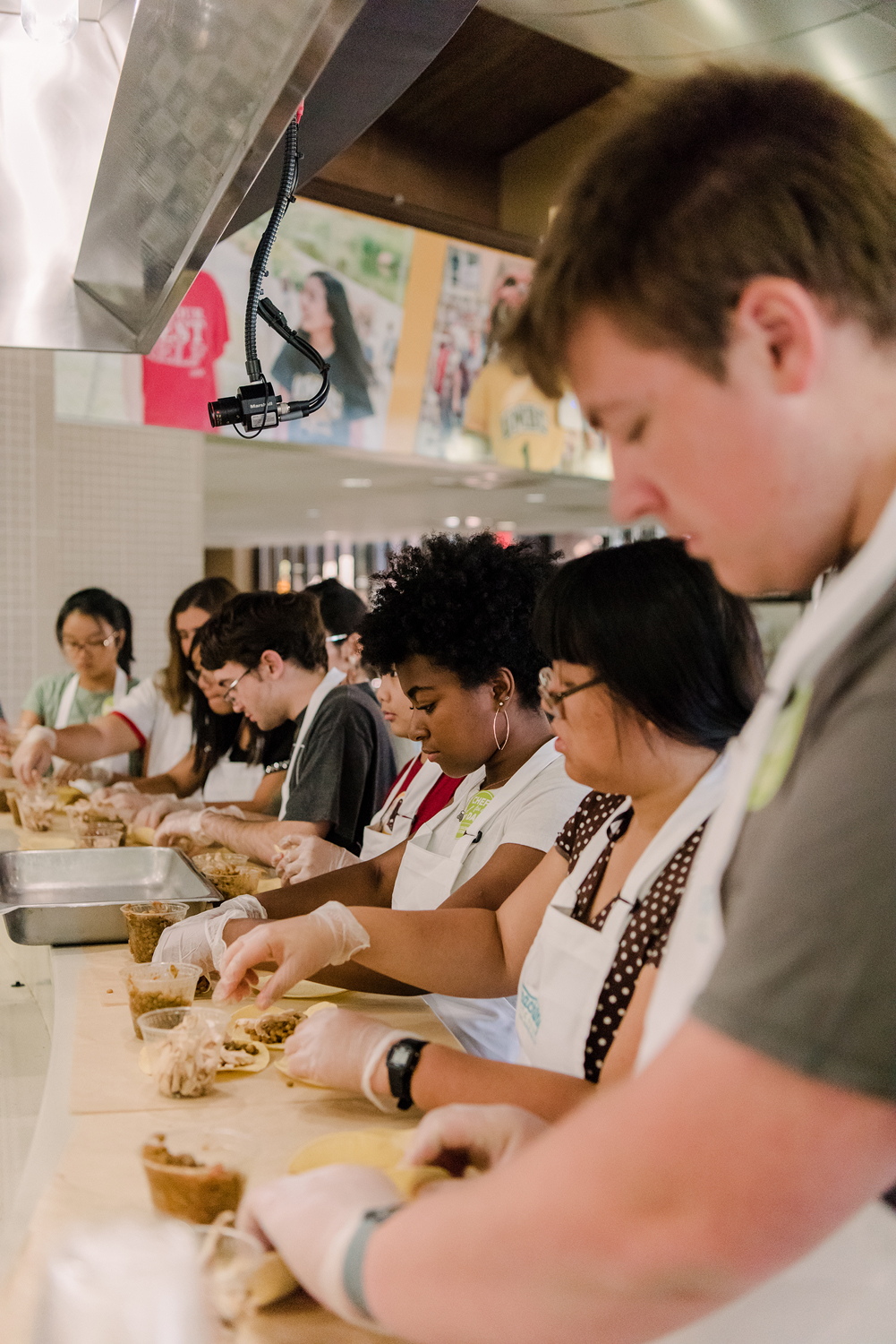 students in aprons in cooking line