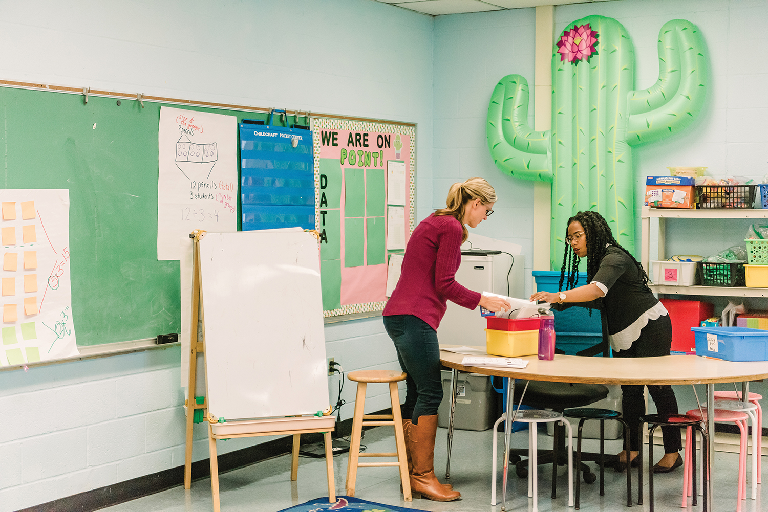 Lydia Coley and the teacher organize papers in a box