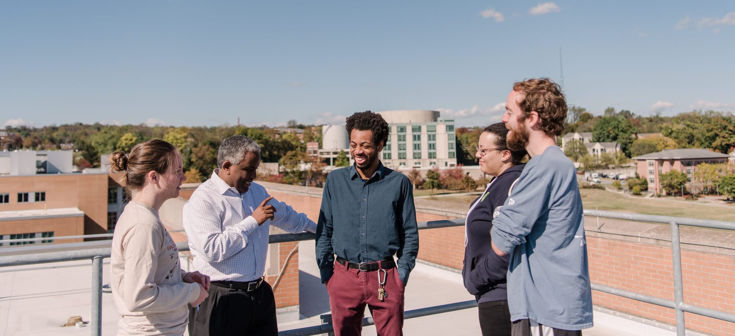 Five people on a rooftop at UMBC.