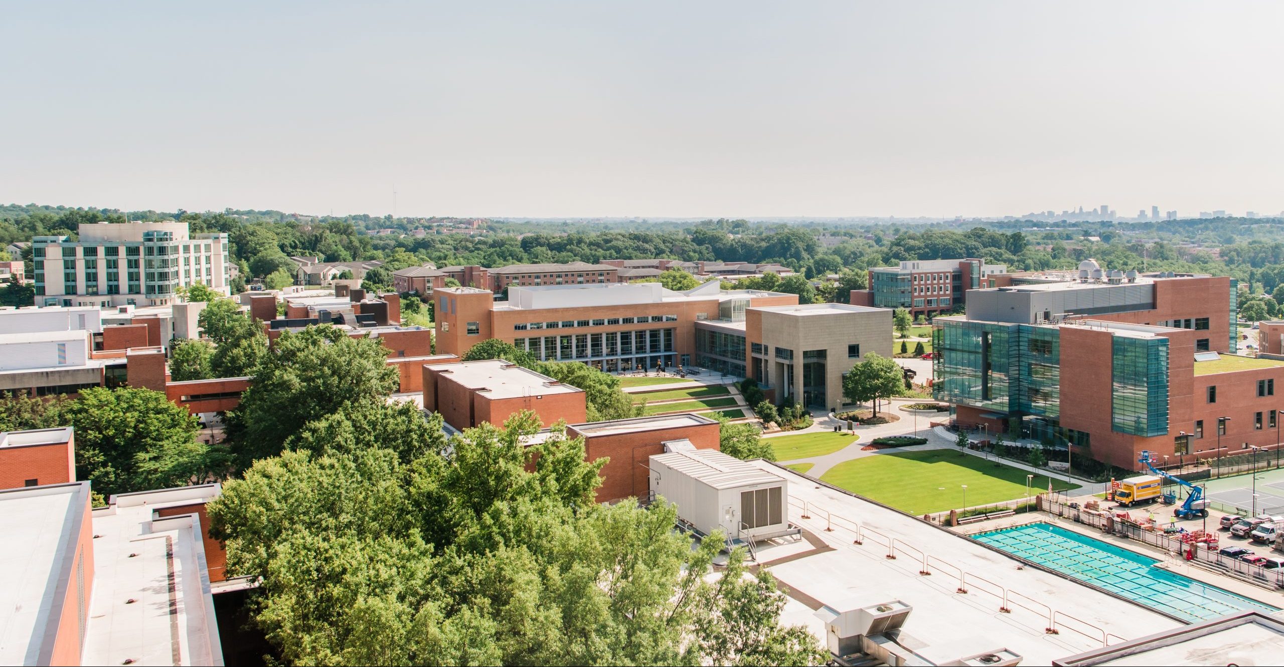 A university campus as seen from above, with several large buildings and the tops of trees.