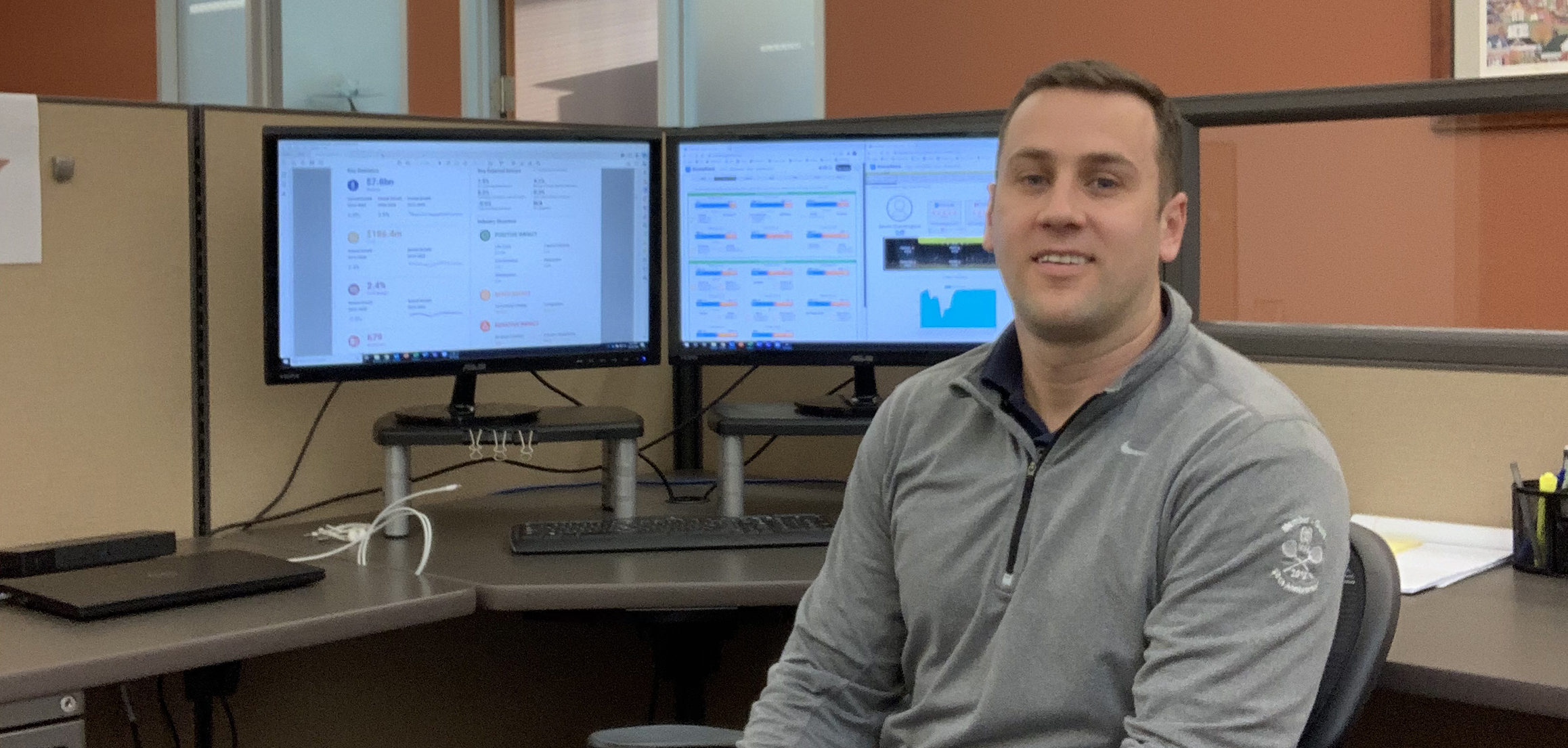 Chris Adams sitting in a chair in front of computer.