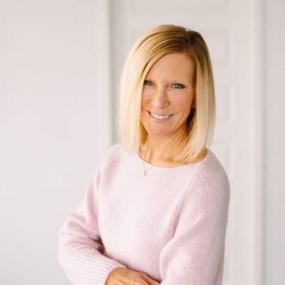 Woman standing in front of blank wall. 