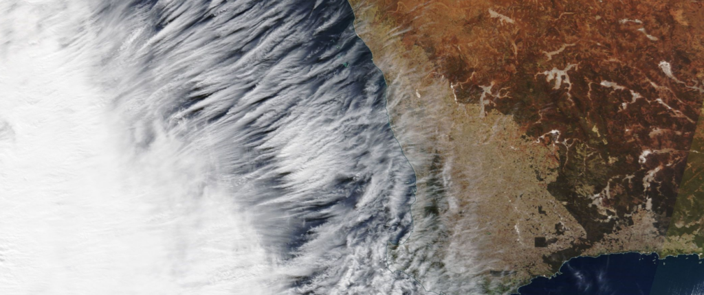 satellite image of clouds along a coastline