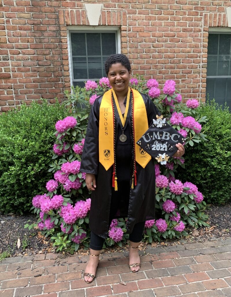 Graduate outdoors with decorated cap 