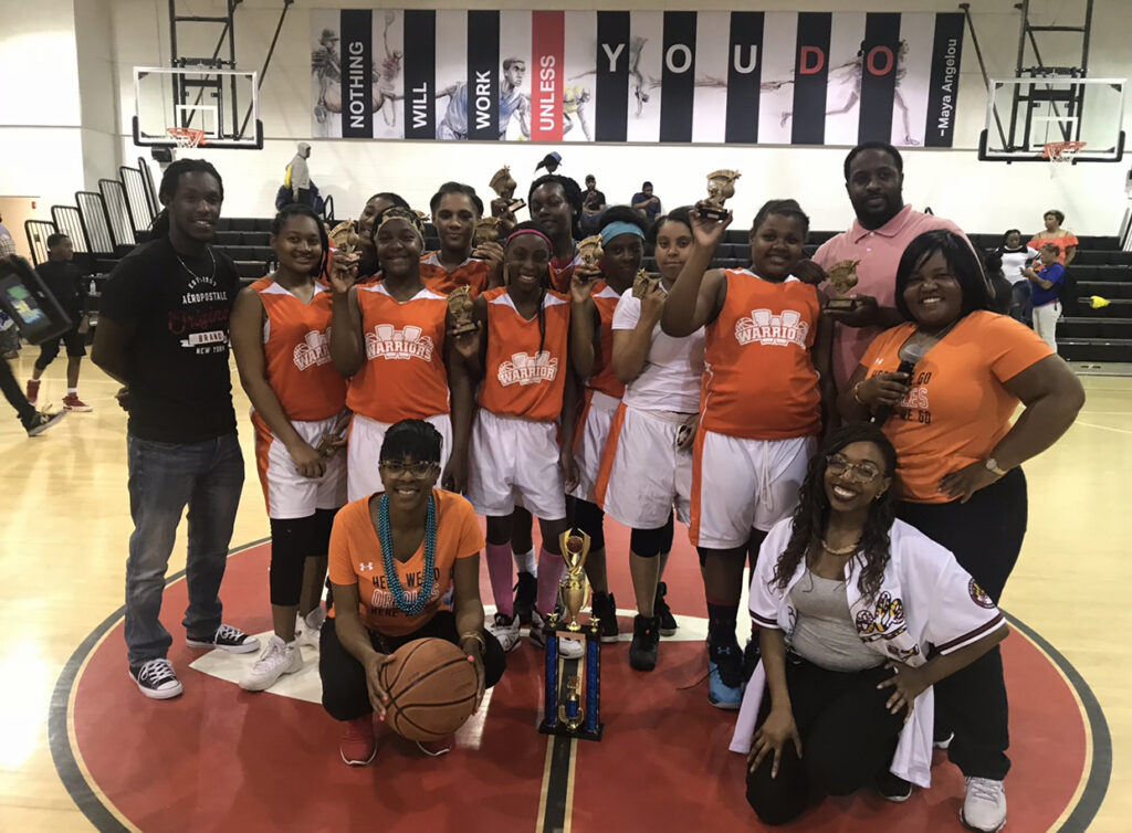 Wilson (far right) hosted a basketball tournament for South Baltimore youth who had perfect or improved attendance.