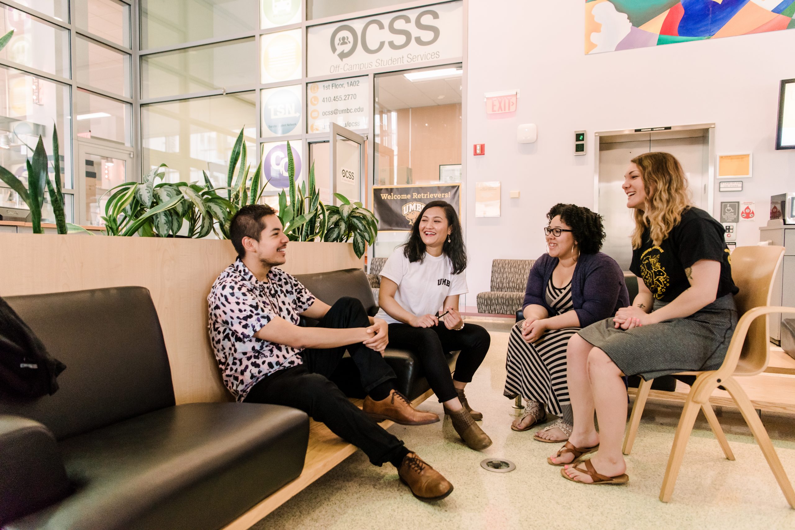 a diverse group of young adults sitting and working together