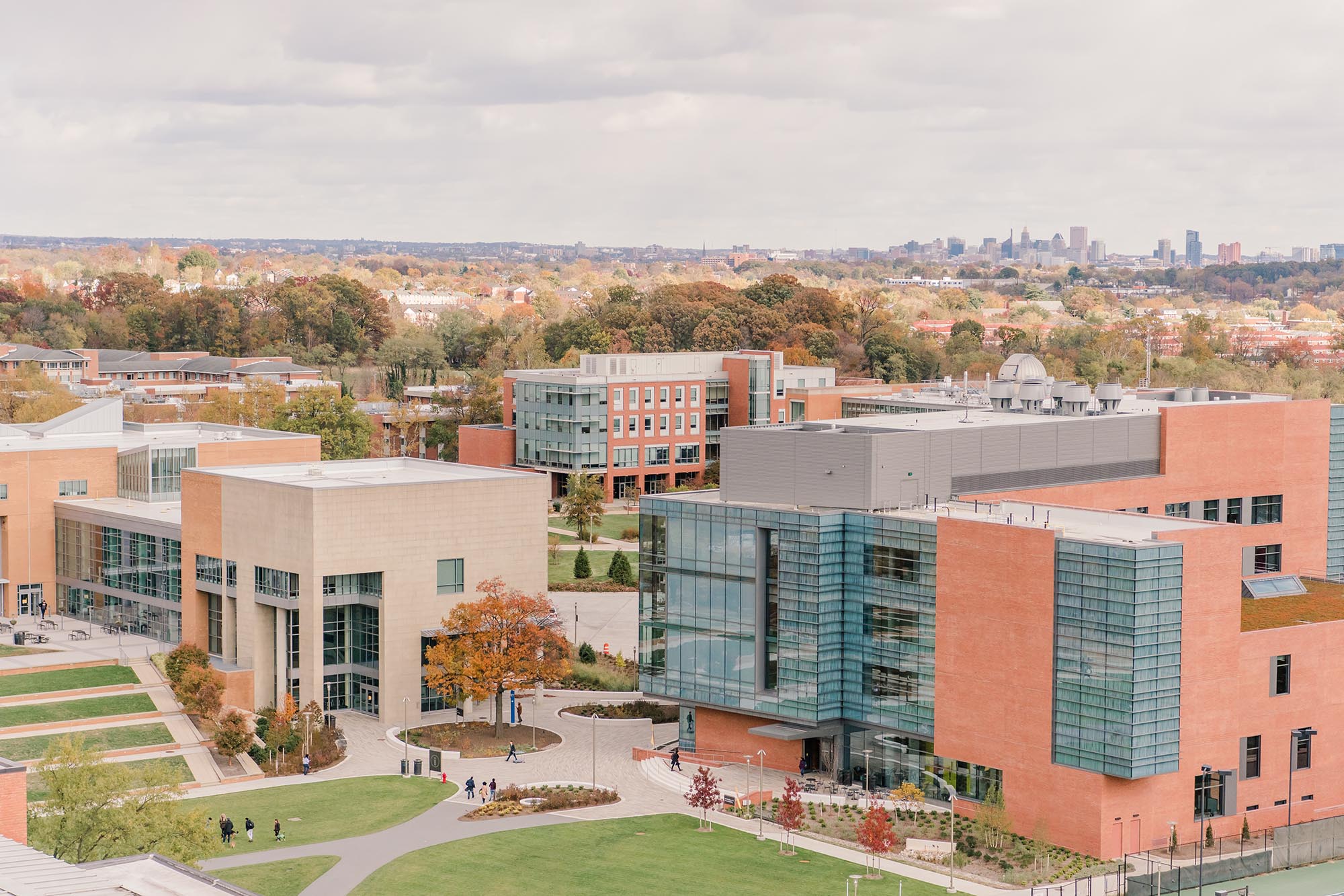 UMBC's campus viewed from above, with the Baltimore skyline in the distance.
