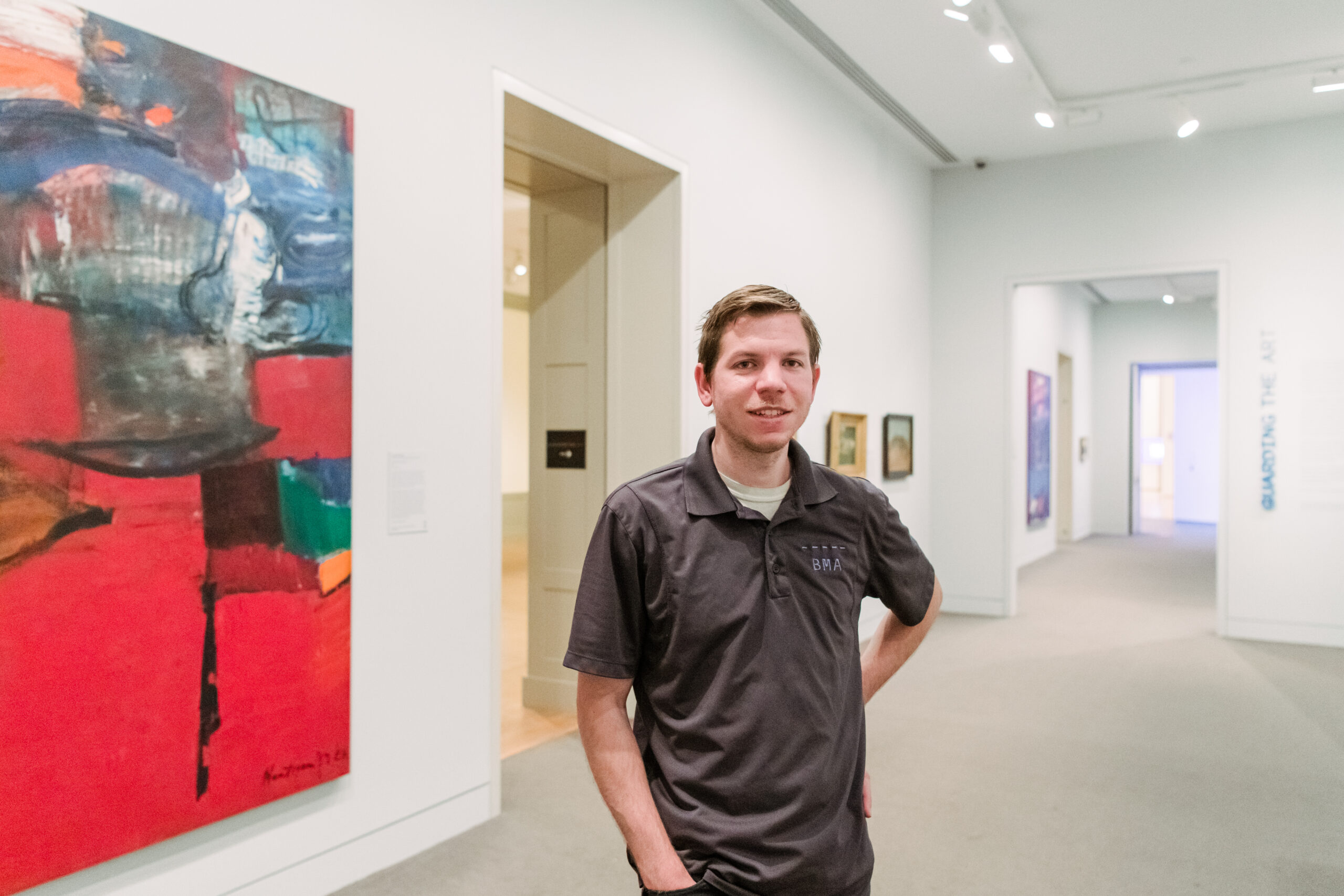 Man stands in front of artwork
