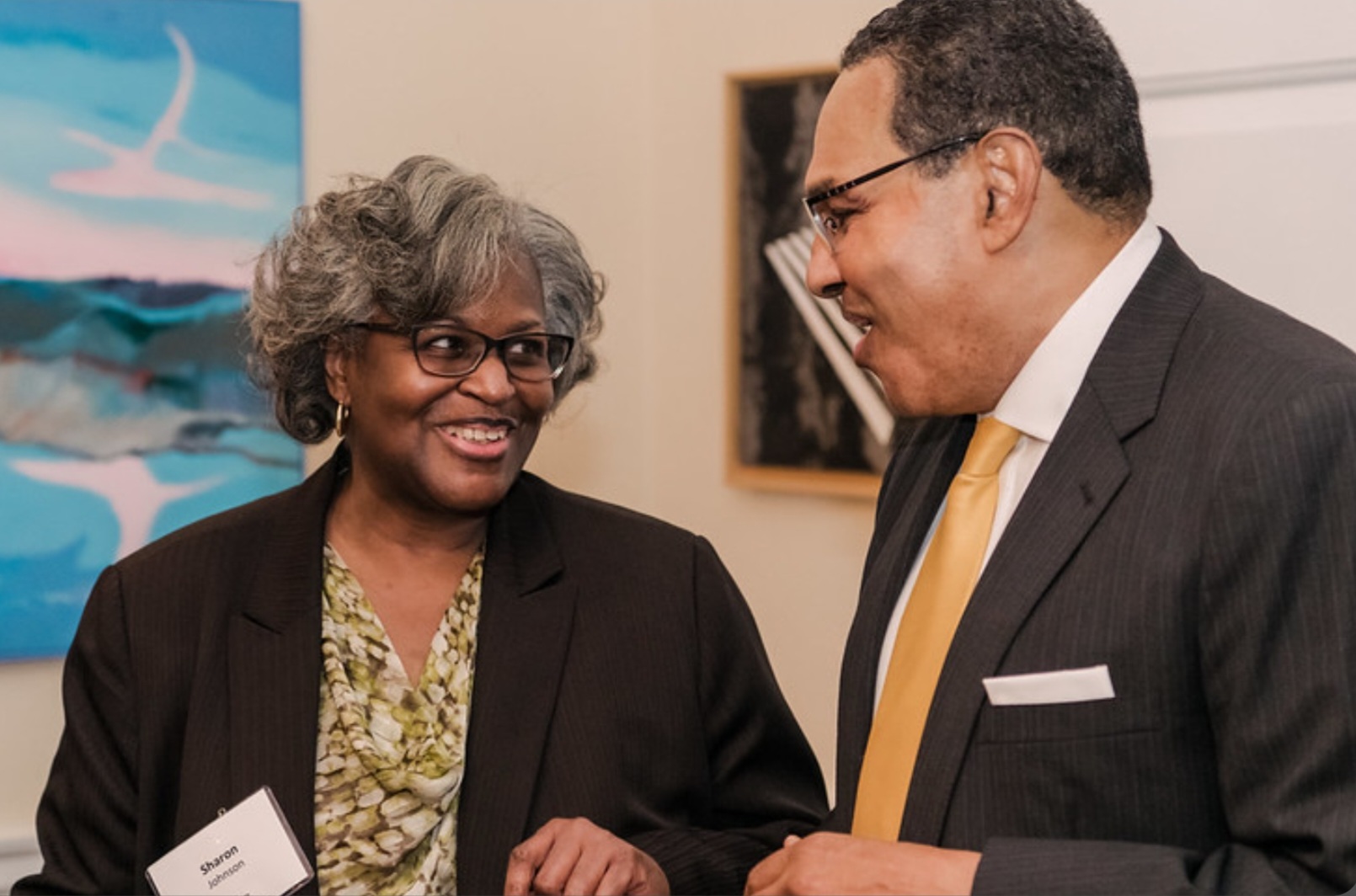 a woman and man talking and smiling