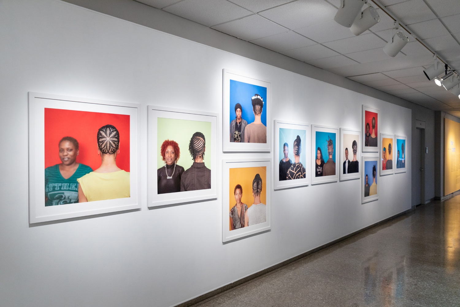 Sonya Clark's Hair/Craft exhibit at the AOK Library Gallery. Images of the front and back's of Black hair styles.