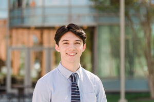 Student on UMBC campus smiling for photo