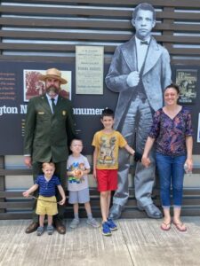 National parks superintendent Jim Bailey poses with his family at the Booker T Washington Monument, a place that celebrates living history