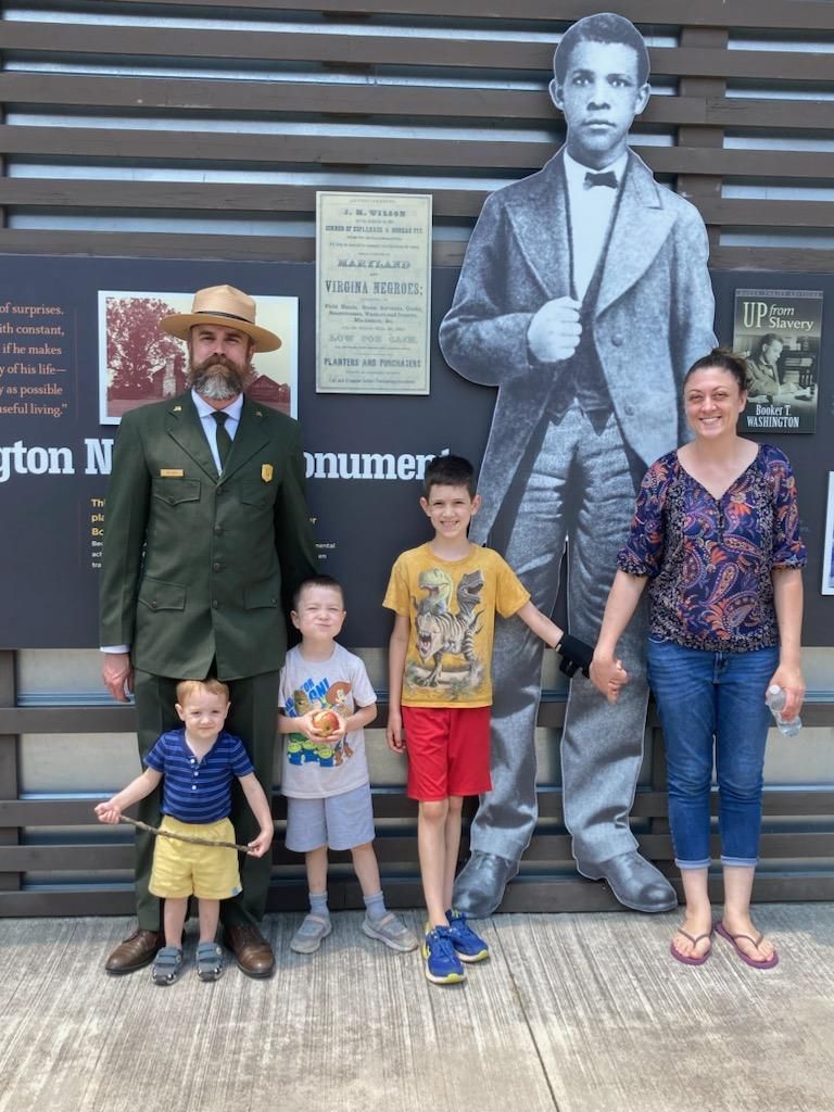 National parks superintendent Jim Bailey poses with his family at the Booker T Washington Monument, a place that celebrates living history