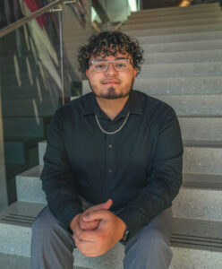 Noah Cruz '24, a psychology and biological sciences student, poses on the stairs.