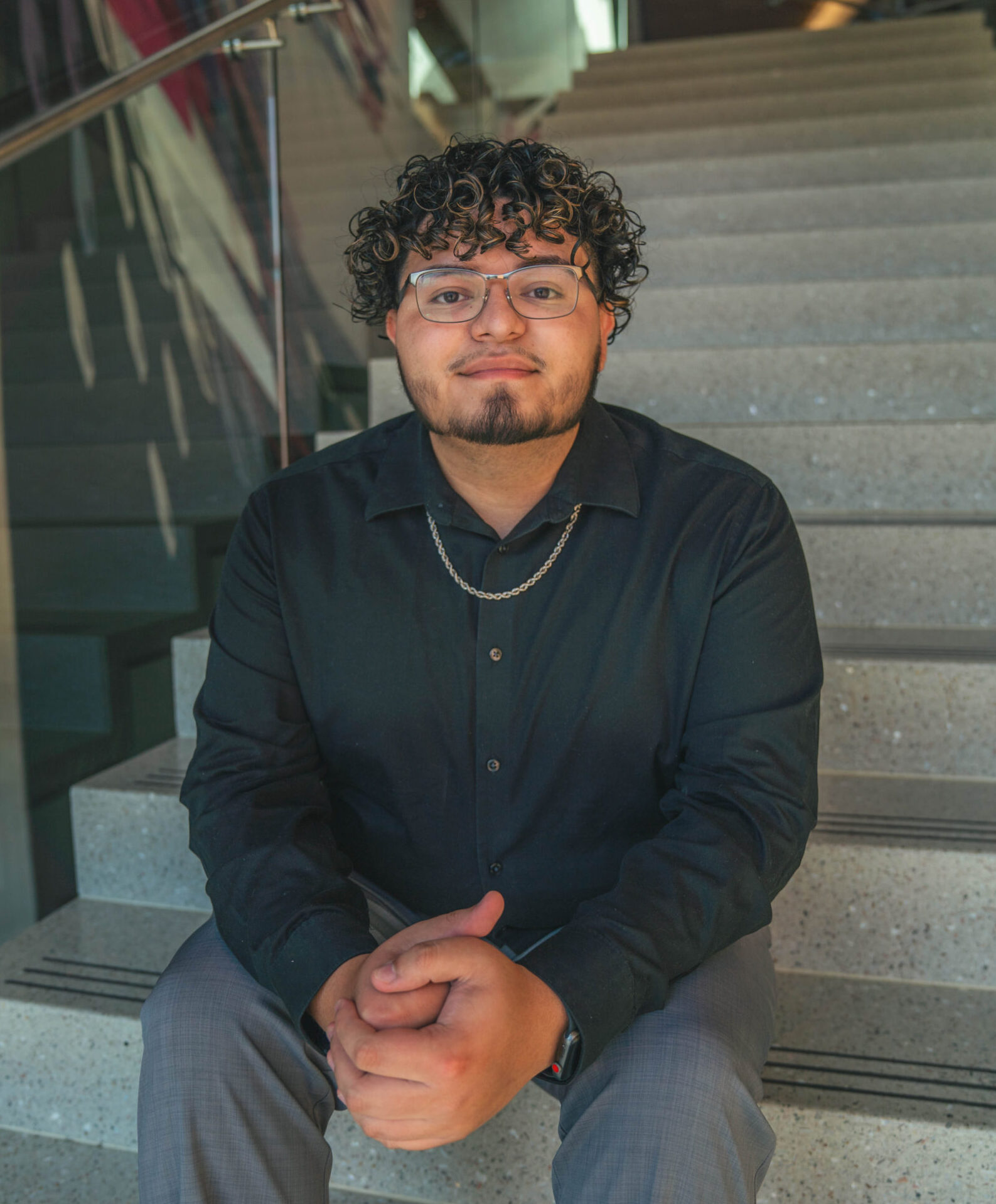 Noah Cruz '24, a psychology and biological sciences student, poses on the stairs.