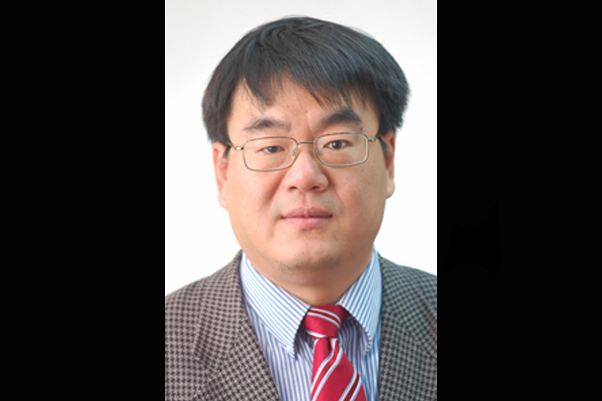 Head shot of man in suit and tie.