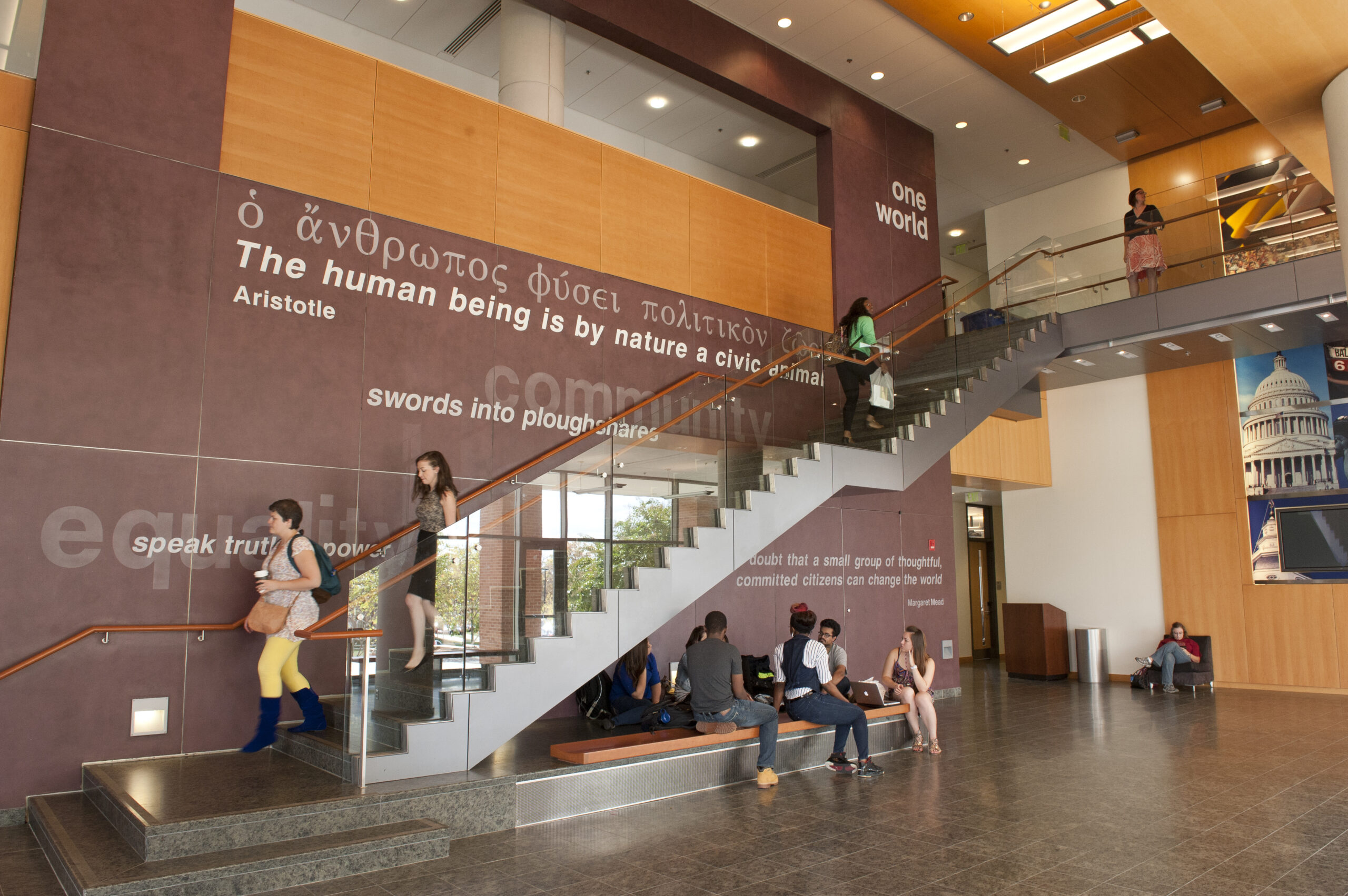 An atrium with a long staircase and large wall with quotes