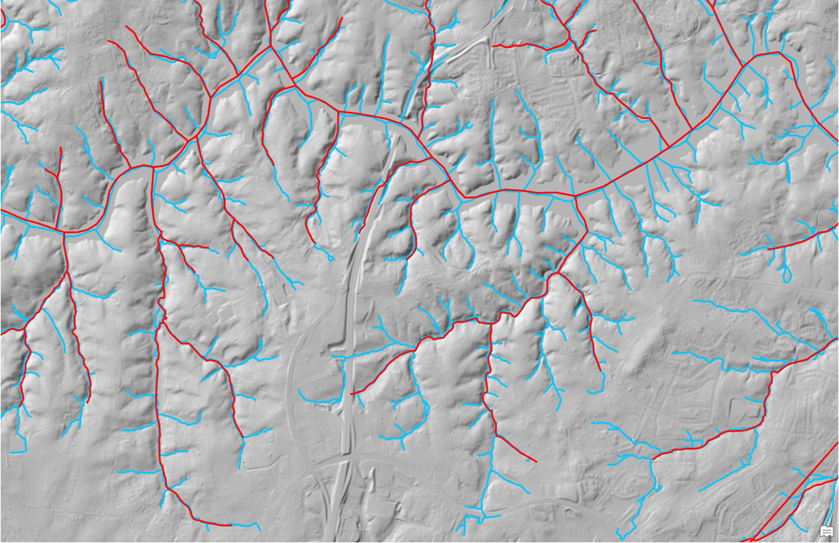gray background topo map with many blue lines representing a stream map, fewer red lines overlaid representing the previous, less complete stream map