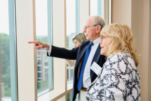 John Ashworth, III with Kim Robinson looking out the AOK Library window.