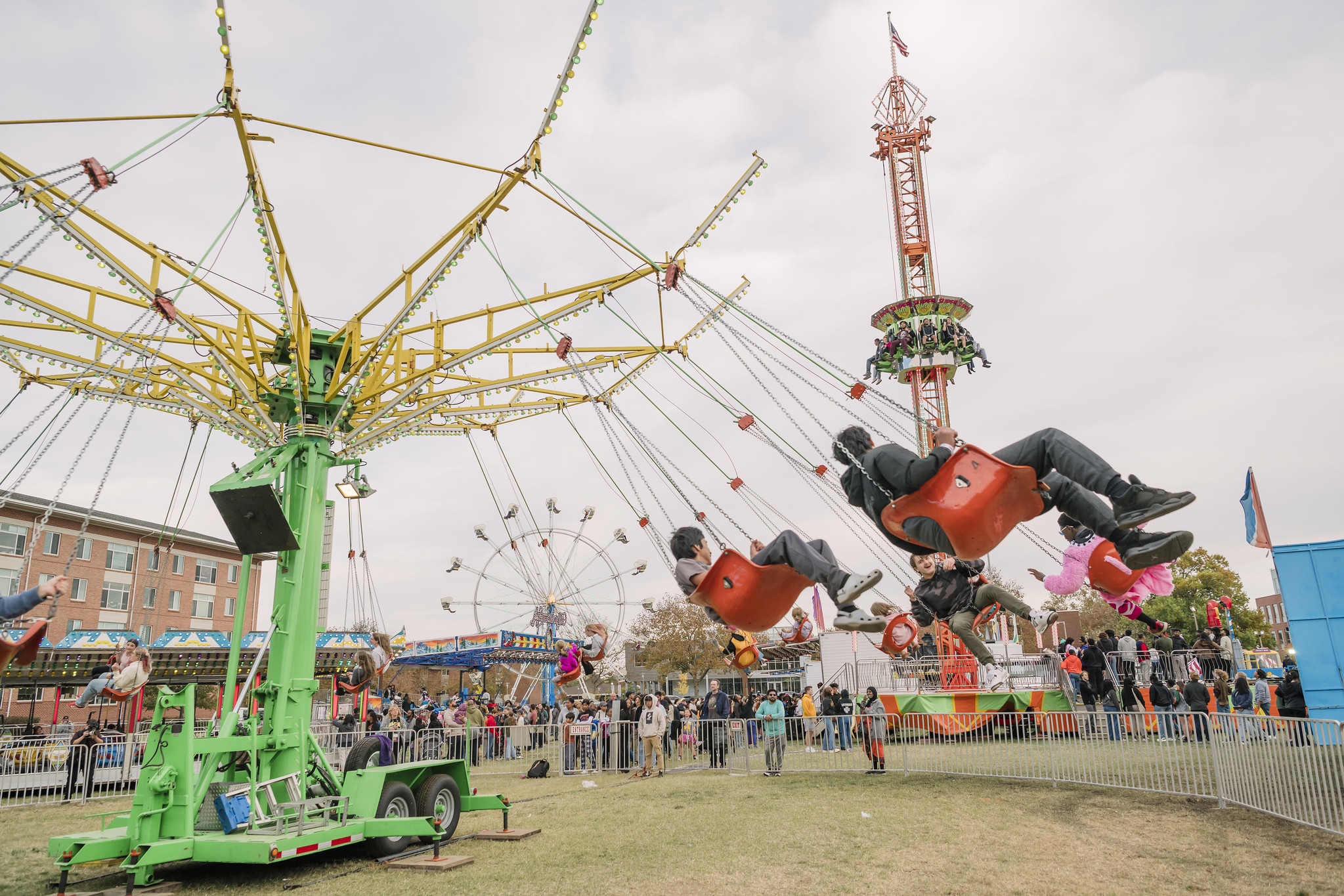 People riding the swings at the 2024 UMBC Homecoming carnival.