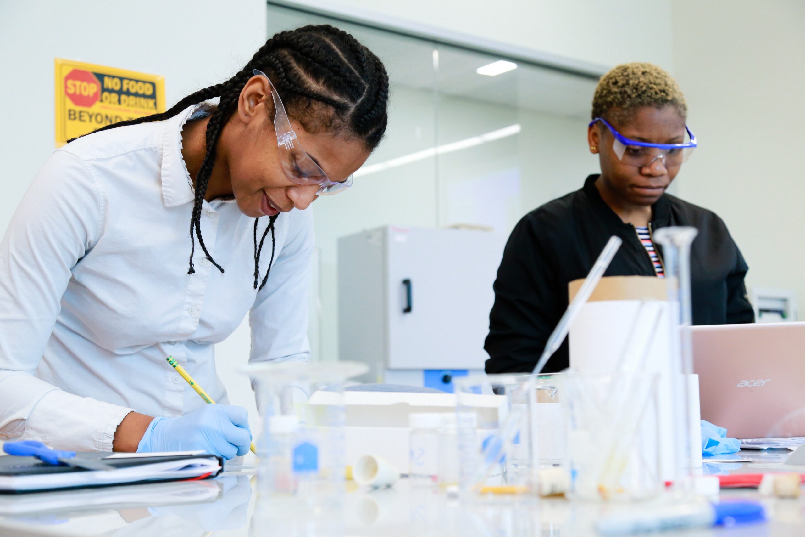Chemist Jacqueline and a student in the lab synthesizing anti-cancer agents.