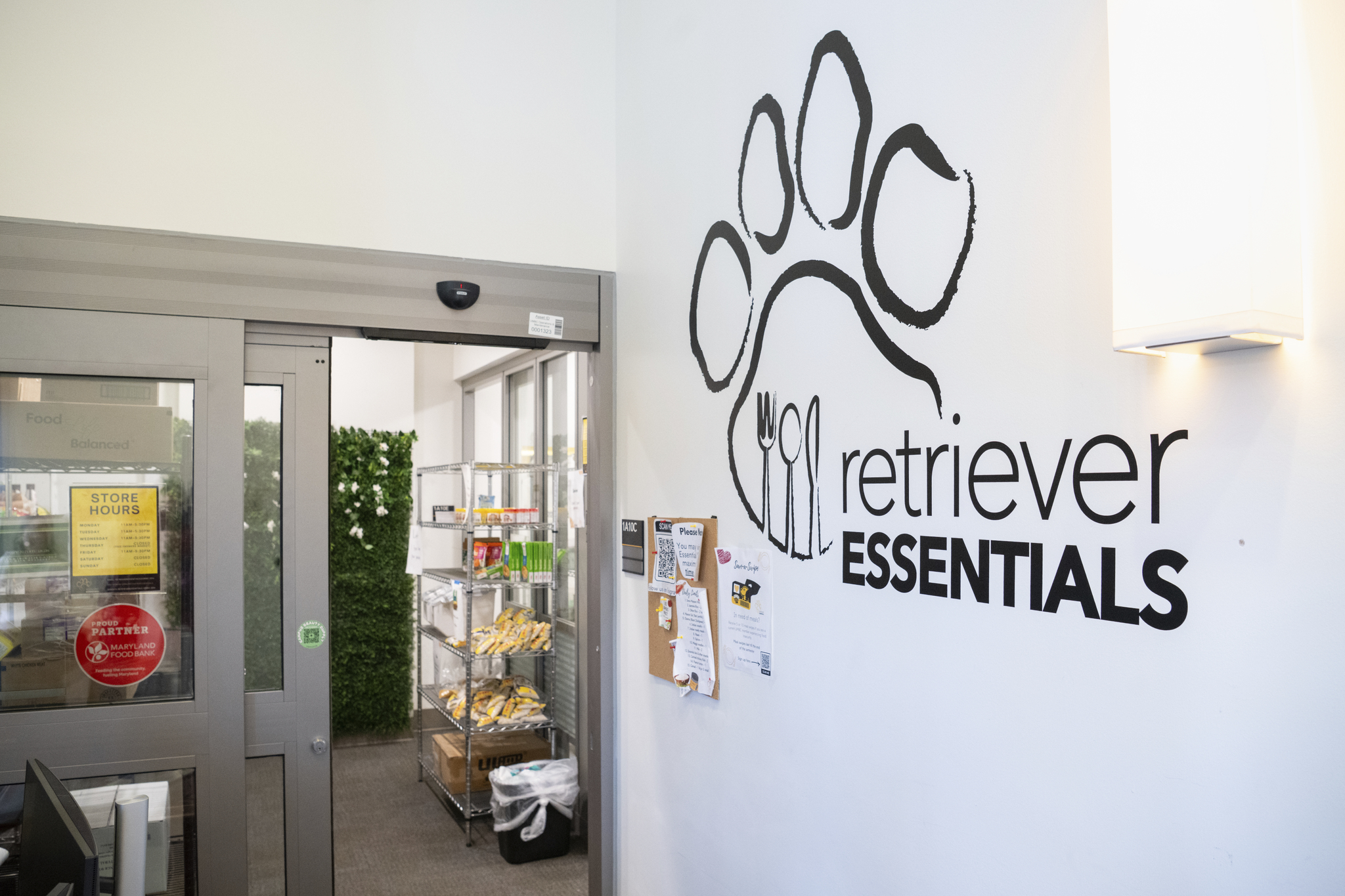 View of wall leading into a food pantry with a paw print logo of "Retriever Essentials"