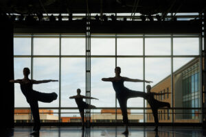 silhouette of dance students posing in unison