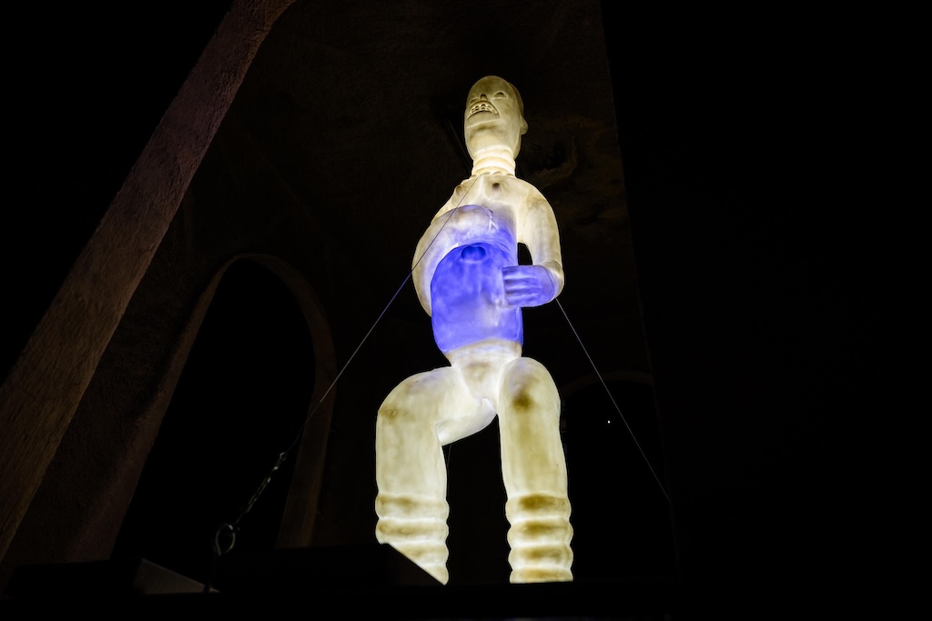 Against a dark background, an artistic rendering of a person is lit in white, except for a blue area in the middle.