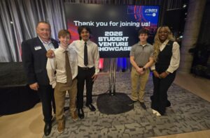 A group of five people stand in front of a sign reading "Thank you for joining us. 2026 Student Venture Showcase."