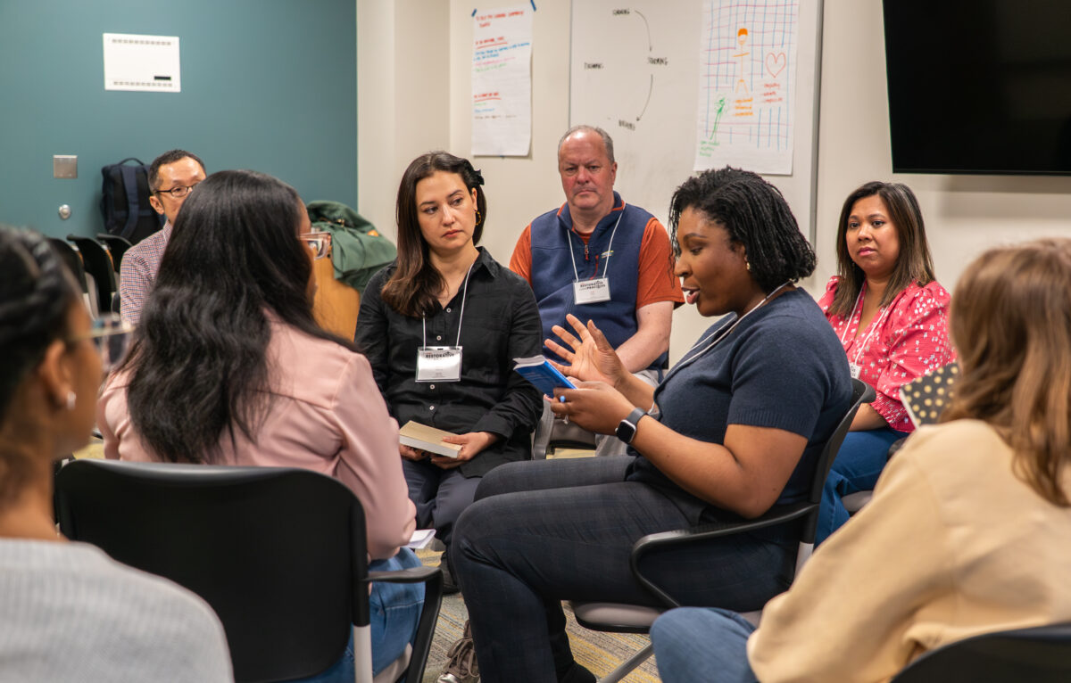 Group of people sitting in a circle having a discussion