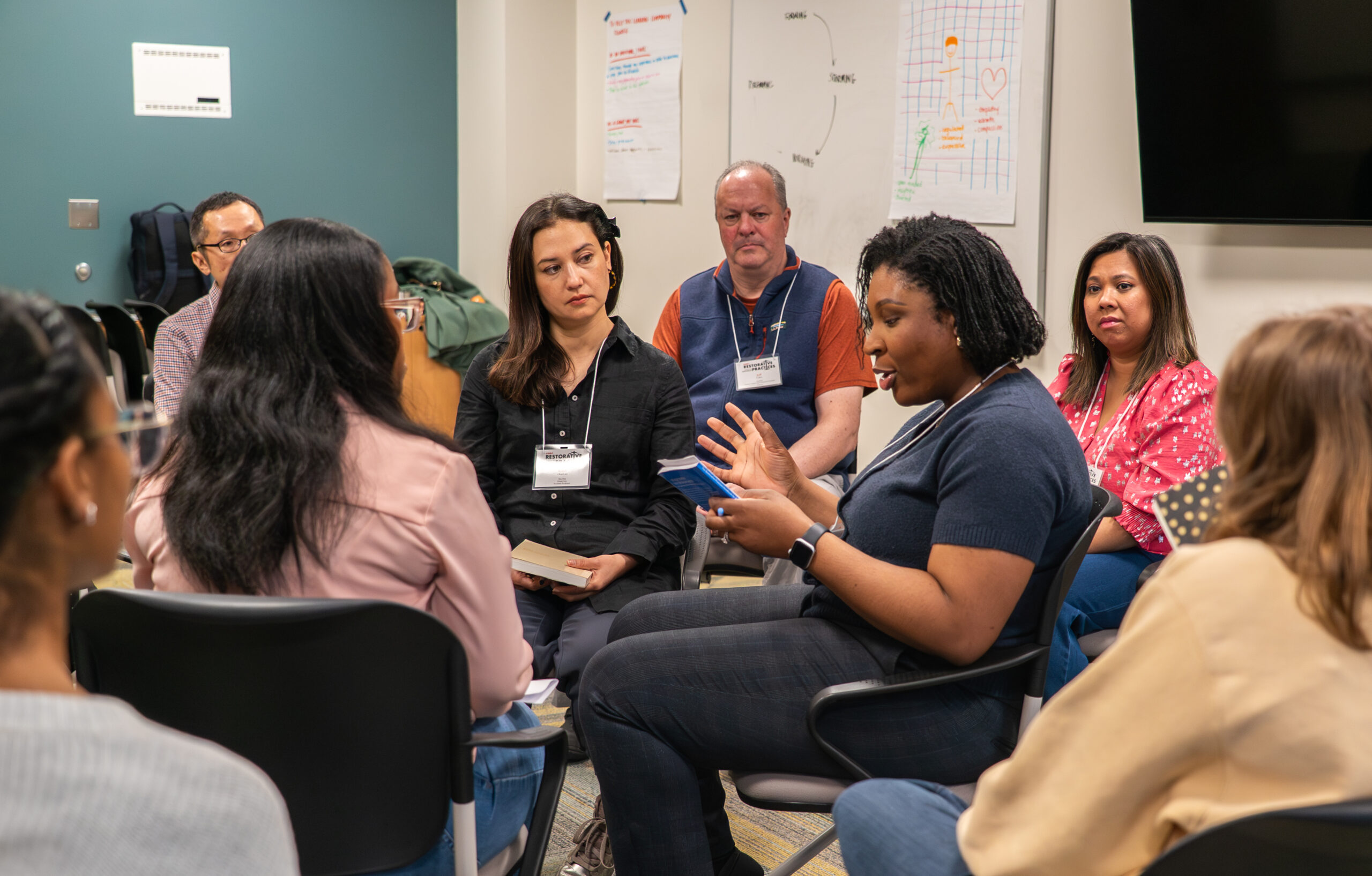 Group of people sitting in a circle having a discussion