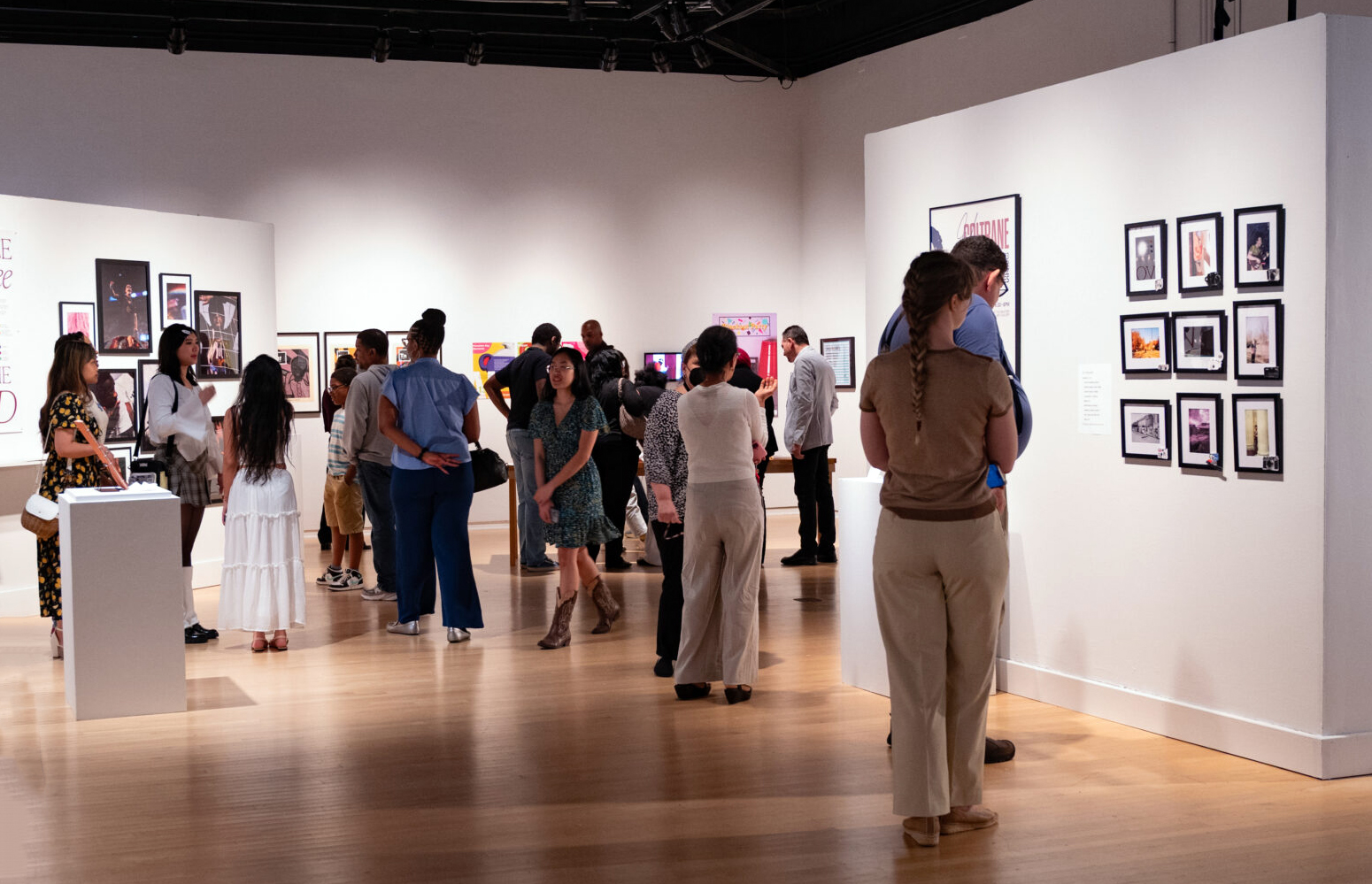 A group of people viewing art in a gallery.