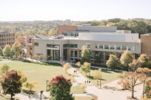 Aerial view of people walking on paths near UMBC buildings in fall.