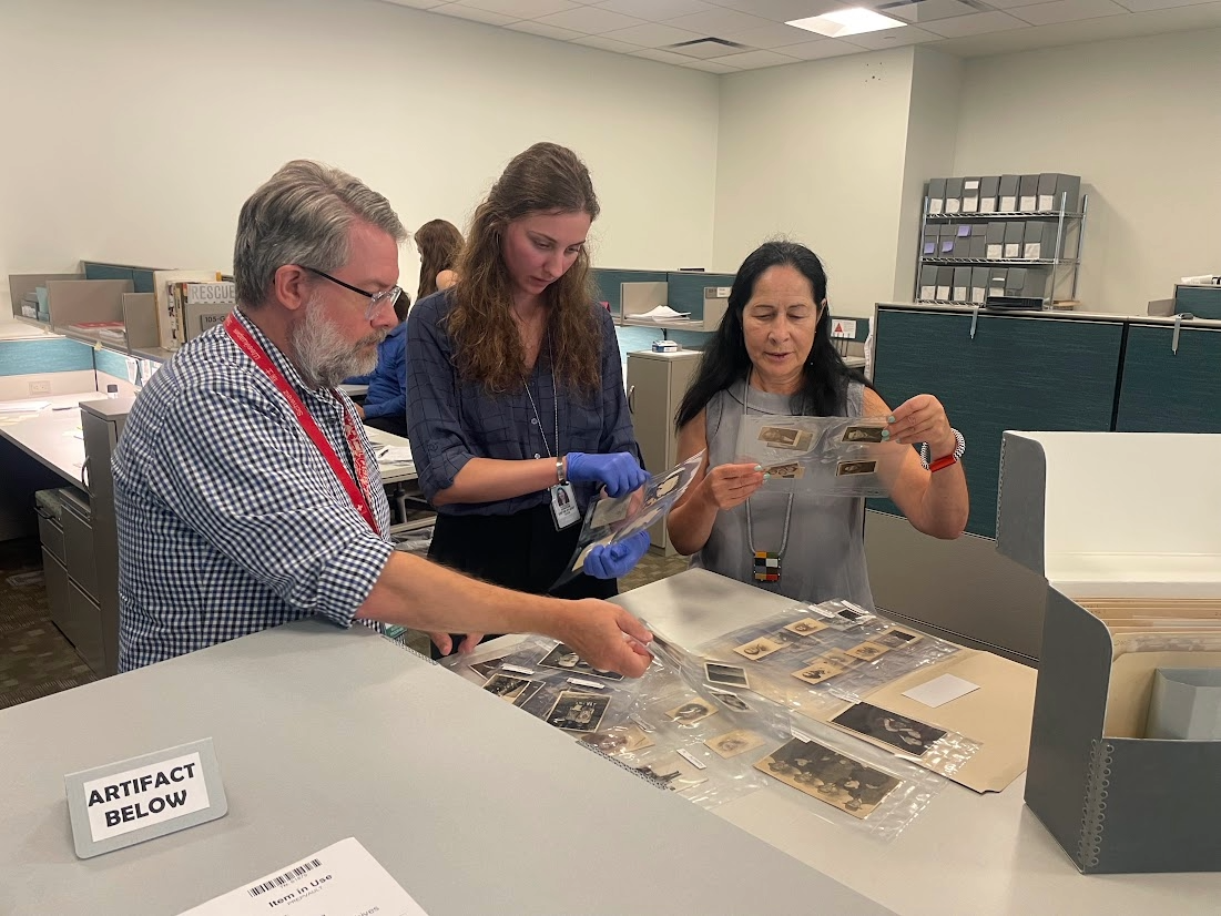 Reese Finnigan’s an intern at the U.S. Holocaust Memorial Museum Shapell Research Center looks through black and white photographs of Jewish people before and during WWII.